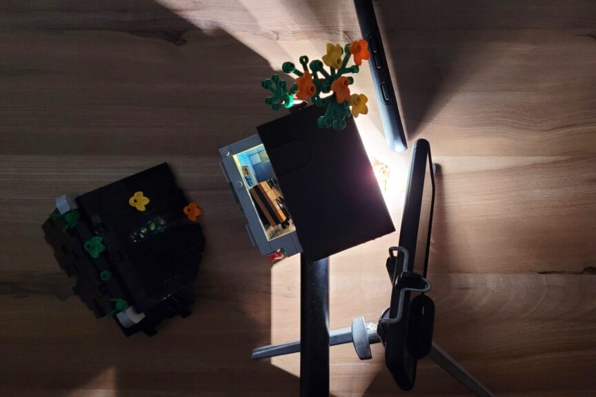 Two phone flashlights shining at a LEGO chapel